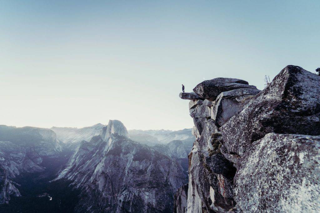 A person standing on the edge of a cliff.